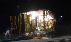 Roadside stand selling garlands and flower petals for the holiday. 