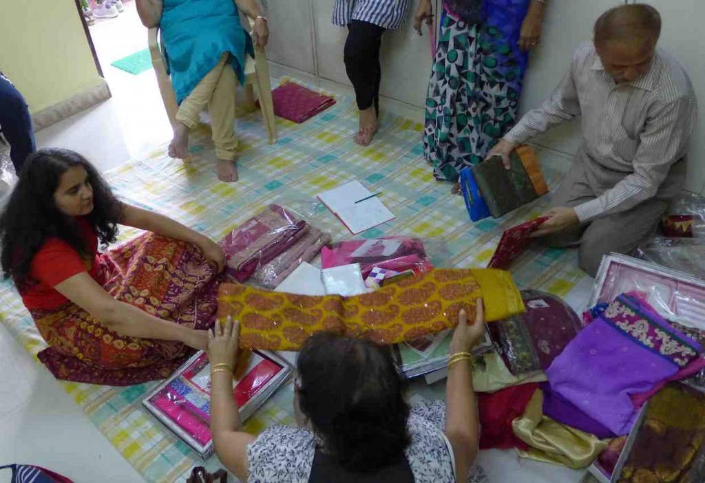 At the seamstress, looking at sarees before measurements were taken.